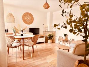 a living room with a table and chairs at Beach House Sea-Esta in Egmond aan Zee