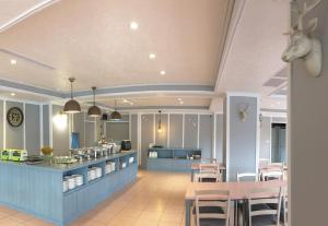 a restaurant with a table and chairs and a kitchen at Wan Tai Hotel in Chiayi City