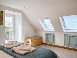 a bedroom with skylights and a bed in a attic at The Cheese Loft in Drummore +11 photos