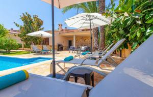 a group of chairs and umbrellas next to a pool at Mirte in Sa Coma