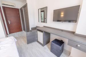 a room with a desk with a tv on the wall at Olinda Hotel & Spa in Şile