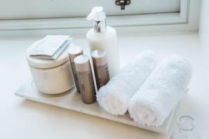 a shelf with towels and other bathroom items on it at One Shore Street in Donaghadee