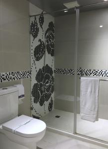 a bathroom with a toilet and a glass shower at Wan Tai Hotel in Chiayi City