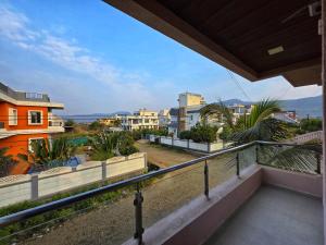 a balcony with a view of a city at ll EMPYREAN STAYS ll SUPREME VILLA II 3BHK II AC II PVT POOL II MINI BAR in Lonavala