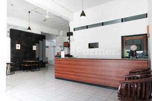 a bar in a restaurant with a counter and chairs at Katup Guest House Syariah Mitra RedDoorz in Yogyakarta