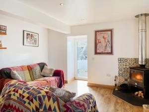 a living room with a couch and a fire place at The Cheese Loft in Drummore