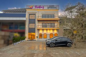 a black car parked in front of a building at Sterling Saryu Ayodhya in Ayodhya
