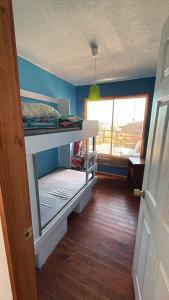 a small room with a bunk bed and a window at Cabaña Las Cruces in Las Cruces
