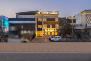 a building with a car parked in front of it at Sterling Saryu Ayodhya in Ayodhya