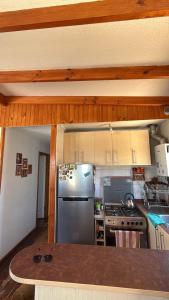 a kitchen with a stainless steel refrigerator and a stove at Cabaña Las Cruces in Las Cruces