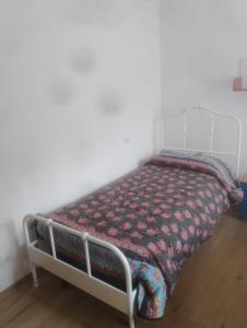 a bed in a room with a blanket on it at Casa Di Leonardo in Loreto