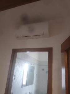 a ceiling in a room with a bathroom with a door at Casa Di Leonardo in Loreto