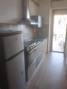 a kitchen with a refrigerator and a stove top oven at Casa Di Leonardo in Loreto