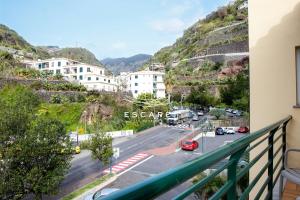 a view from a balcony of a street with cars at Anavrin by Escape to Madeira in Ponta do Sol