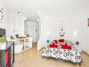 a bedroom with a black and white bed with red pillows at 1316 Paraiso Sur, Amazing view in Playa Paraiso +34 photos