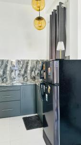 a kitchen with a stainless steel refrigerator and a light at Jameens Residence in Ambalangoda