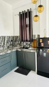 a kitchen with a refrigerator and a counter top at Jameens Residence in Ambalangoda +18 photos