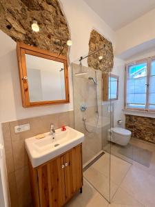 a bathroom with a sink and a shower and a toilet at FeWo Altes Doktorhaus in Berchtesgaden +40 photos