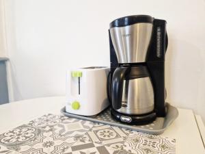 a coffeemaker and a coffee maker sitting on a table at Frégate in Cherbourg en Cotentin
