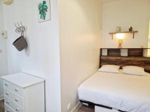 a small bedroom with a bed and a dresser at Frégate in Cherbourg en Cotentin