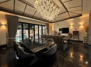 a living room with a glass table and chairs at Somnea Villa in Kampot