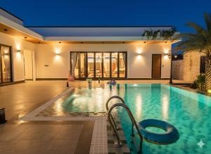 a large swimming pool in a building at Somnea Villa in Kampot
