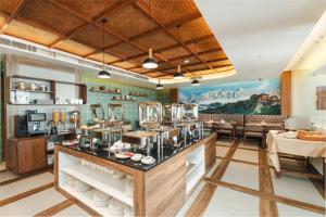 a restaurant with a counter in a room at Mankamana Hillcrest Resort in Makaising