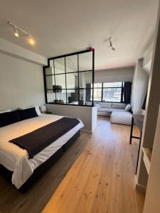 a bedroom with a large bed and a large mirror at 91 Loop Boutique Hostel in Cape Town