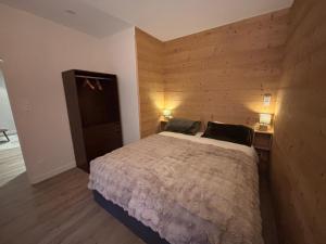 a bedroom with a bed with two pillows on it at Hôtel Le Chalet in Ax-les-Thermes
