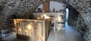 a room with a stone wall with a wooden box at MAS Estrela Chambre Lo Nis in Bessèges