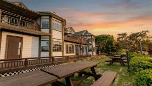 a wooden bench sitting in front of a building at Ganghwa Western Beach Pension in Incheon
