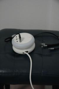 a white device sitting on top of a black couch at Athalassas corner in Strovolos
