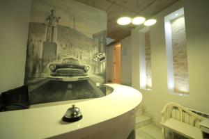 a room with a wall with a painting on the wall at Hotel Nicolo in Tbilisi City