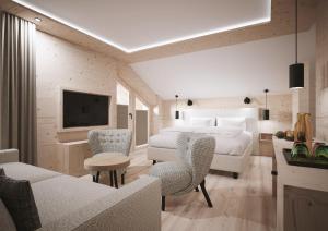 a bedroom with a bed and a living room at Gorfion Familienhotel in Malbun