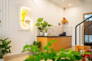 a kitchen with plants on the wall and a counter at Dimori homestay in Hue +53 photos