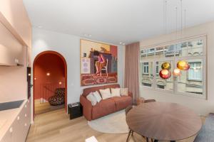 a living room with a couch and a table at stijlvol appt met adembenemend uitzicht op het centrum van Ieper in Ieper +4 photos