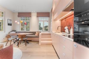 a kitchen and living room with a table and a couch at stijlvol appt met adembenemend uitzicht op het centrum van Ieper in Ieper
