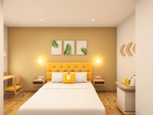 a bedroom with a bed and a desk at Bloom Hotel - ISKCON Rajajinagar in Bangalore