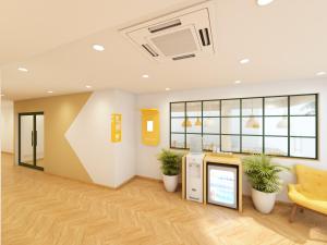 an office lobby with a waiting area with plants at Bloom Hotel - ISKCON Rajajinagar in Bangalore