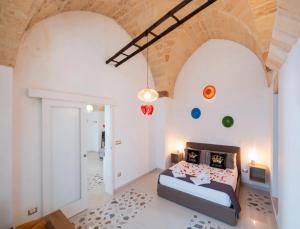 a bedroom with a bed in a room with arch ceilings at Corte Aragonese Suite Spa Privata in Veglie
