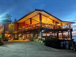 a large building with a large deck and a building at My Honey's Farm in Nangkaan