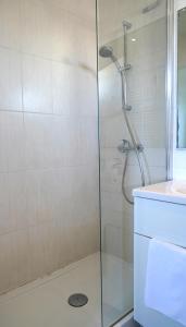 a shower with a glass door next to a sink at MOTEL ASCOT - Hotel & Appartements in Cagnes-sur-Mer +67 photos