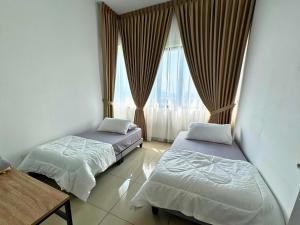 two beds in a room with a window at Almyra cozy condo in Kajang +17 photos