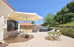 a patio with a table and an umbrella at Amazing Home In Perdifumo in Perdifumo +27 photos