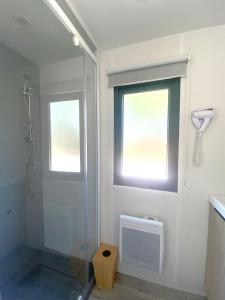 a bathroom with a shower and a window and a shower at Camping du Chêne - proche de Nantes in Saint-Julien-de-Concelles