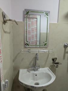 a bathroom with a sink and a mirror at Hotel New Airport in Kathmandu