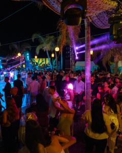 a crowd of people at a party at night at Empire Beach Resort ADULTS ONLY in Dhërmi +183 photos