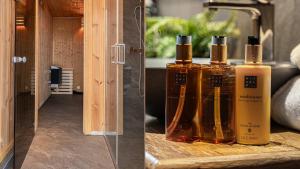 three bottles of oils sitting on a wooden shelf at TH589- Large ski-in out chalet in Trysilfjell with sauna, hottub in Hovi