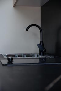 a kitchen sink with a black faucet at Verinn Apart Hotel in Dilijan +21 photos