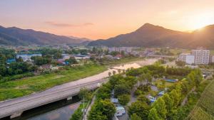 an aerial view of a city with a bridge at Gapyeong Karabankaempingnongwon in Gapyeong +1 photo